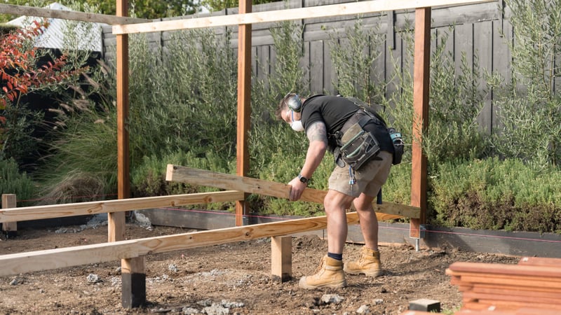 Attaching bearers and joists to support the weight of the entire deck
