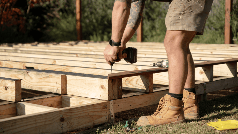 A person is screwing nails into a frame
