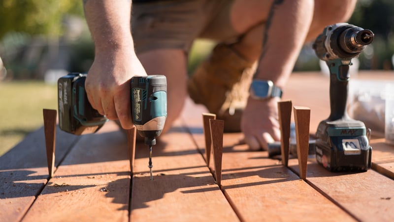 Using drill to screw the boards into the deck