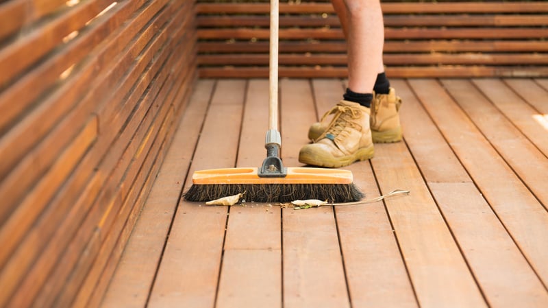 man brushing down deck.