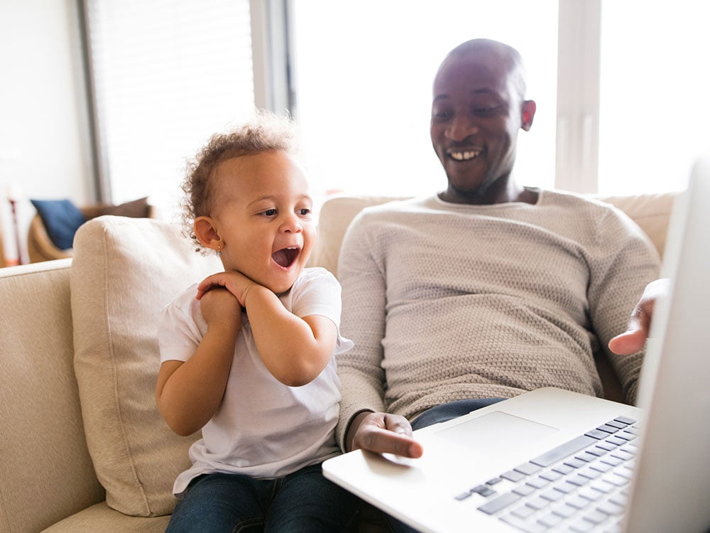 Dad and young son laptop