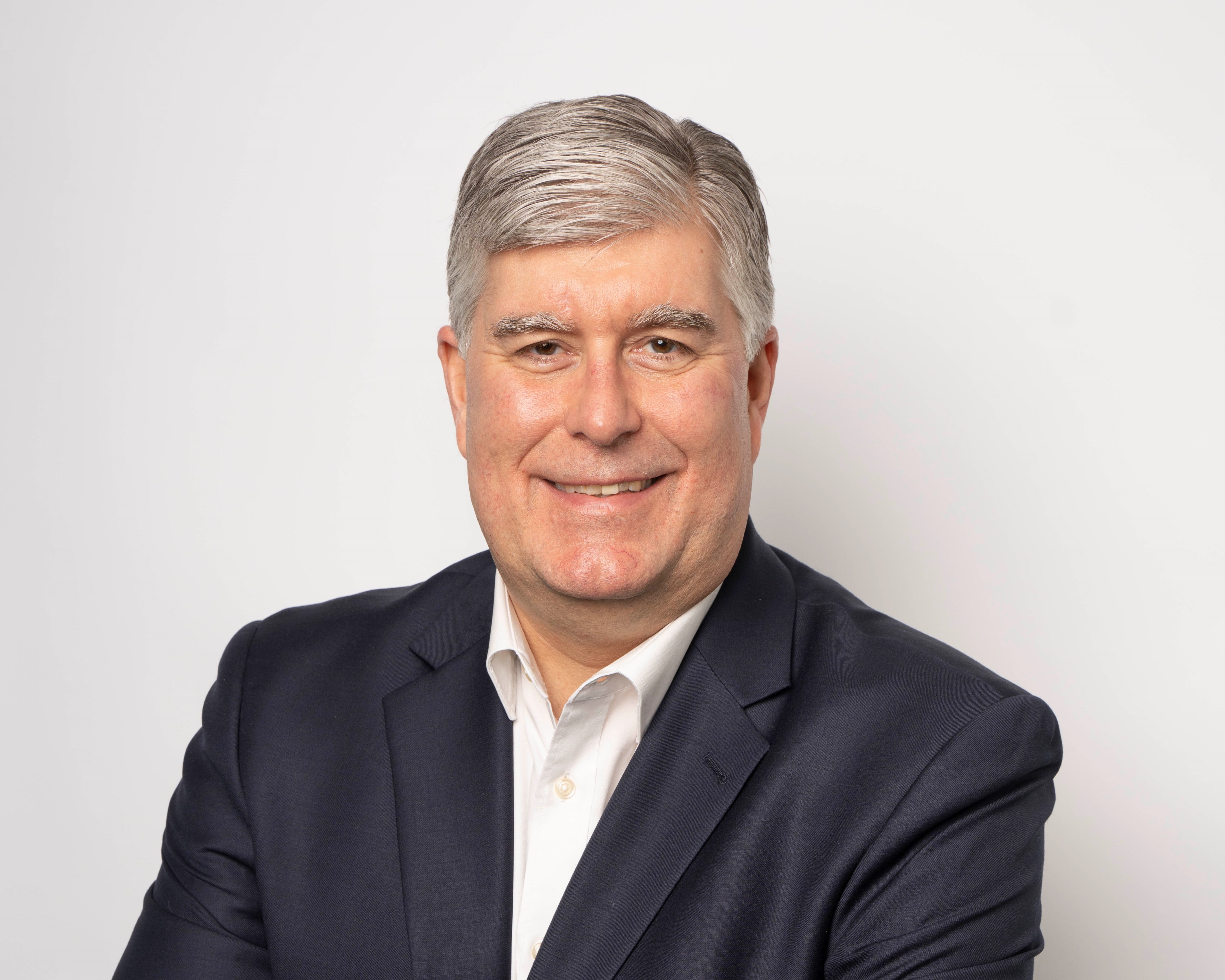 Headshot of David McArthur with a confident, professional expression
