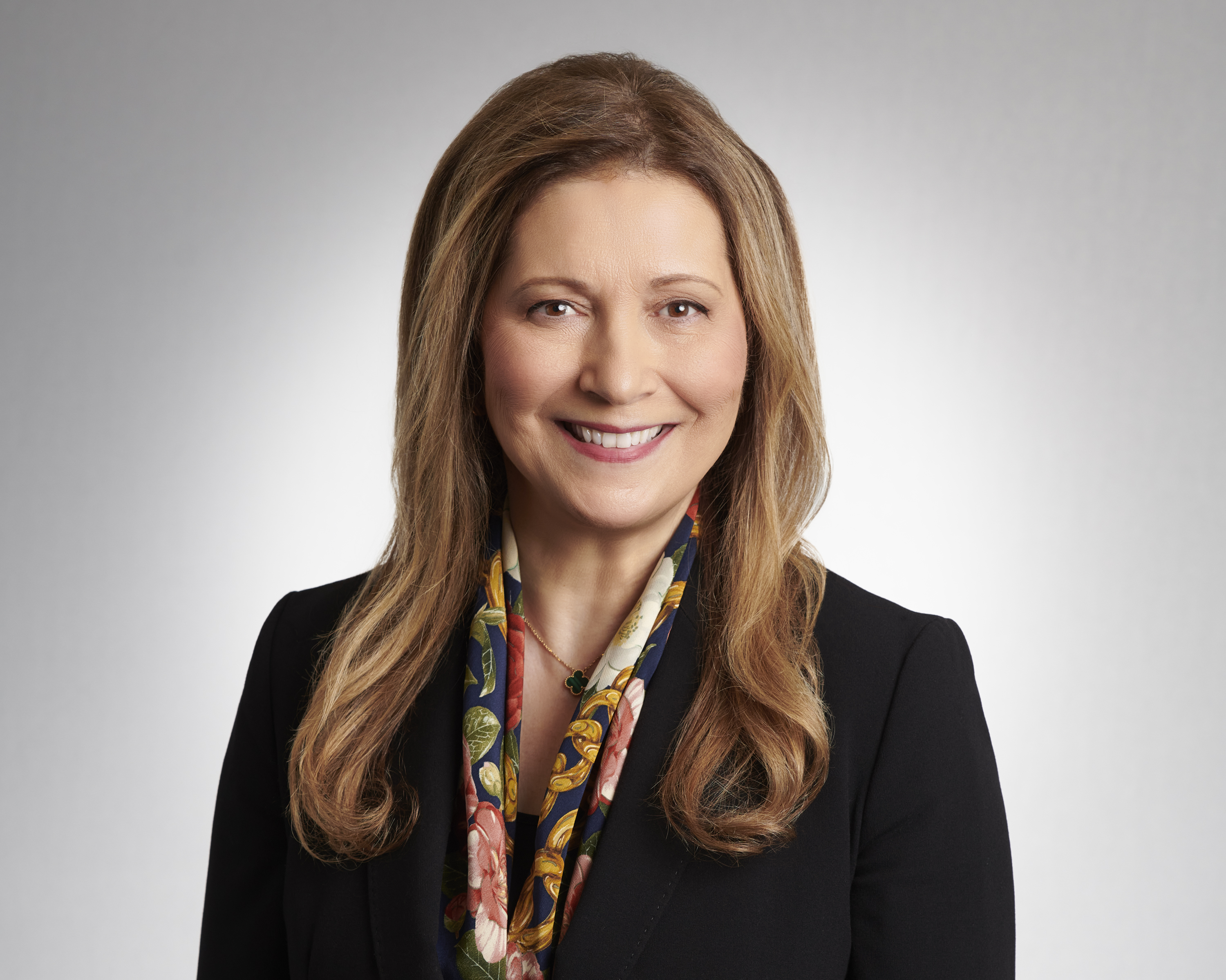 Confident headshot of Giulia Falbo Ahmadi in a neutral setting