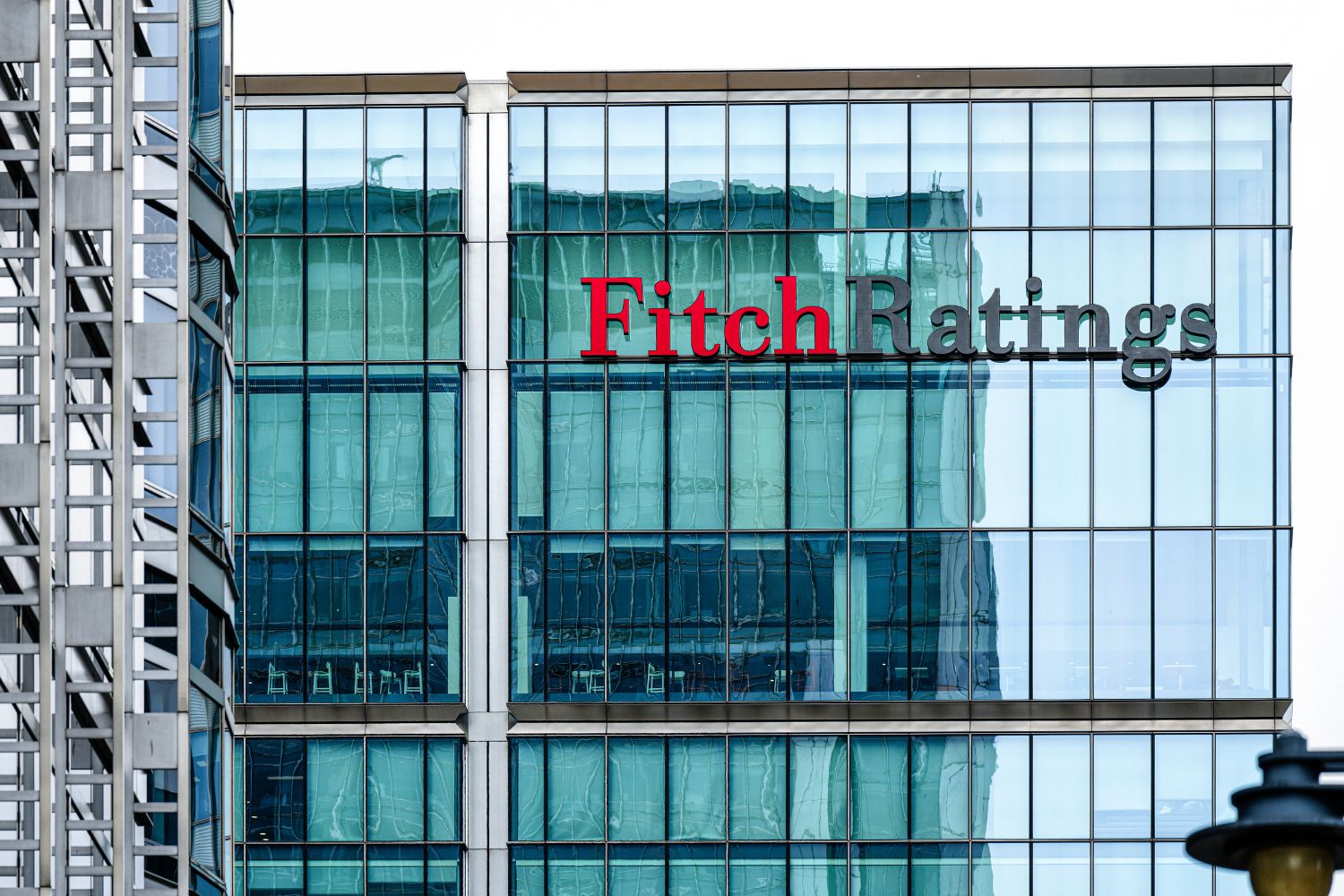 The Fitch Ratings sign on the glass facade of the agency's headquarters