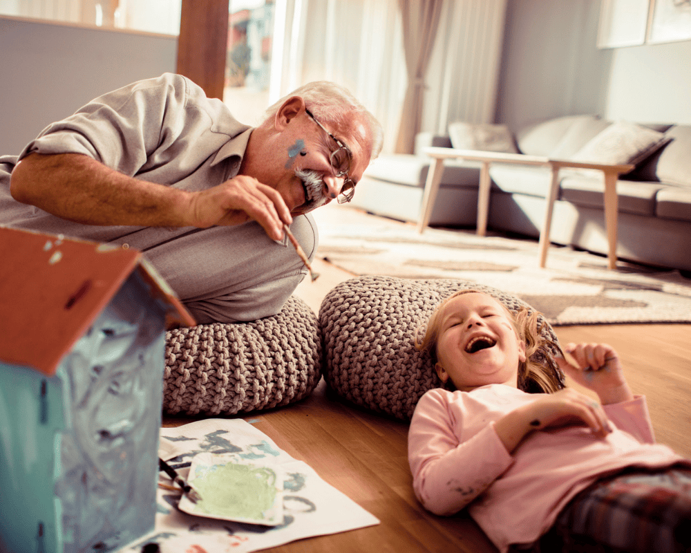 Granddad laughing with his granddaughter