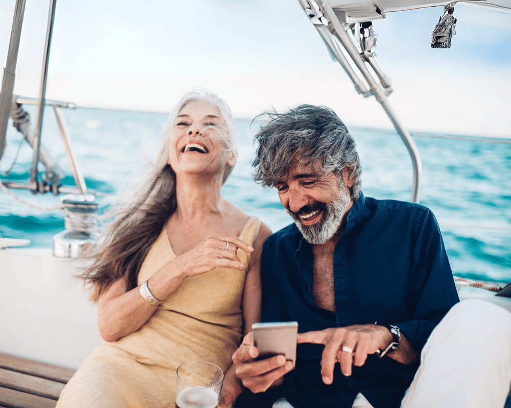 Senior couple on a cruising vacation surfing the net and having fun