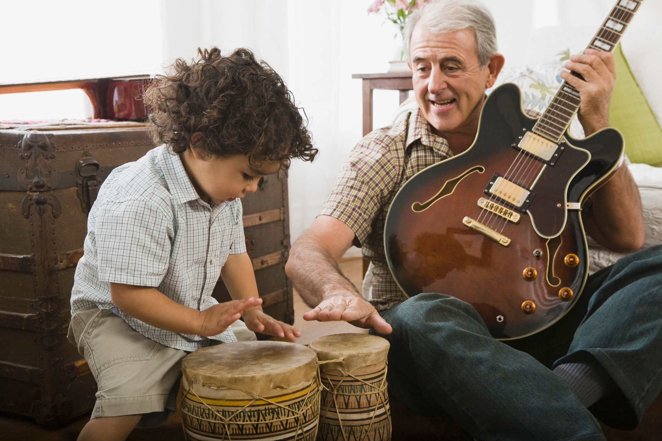 Grandfather and grandson playing musical instruments