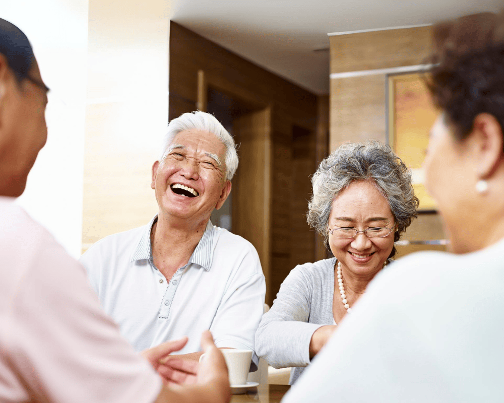 Retirees laughing at the dinner table