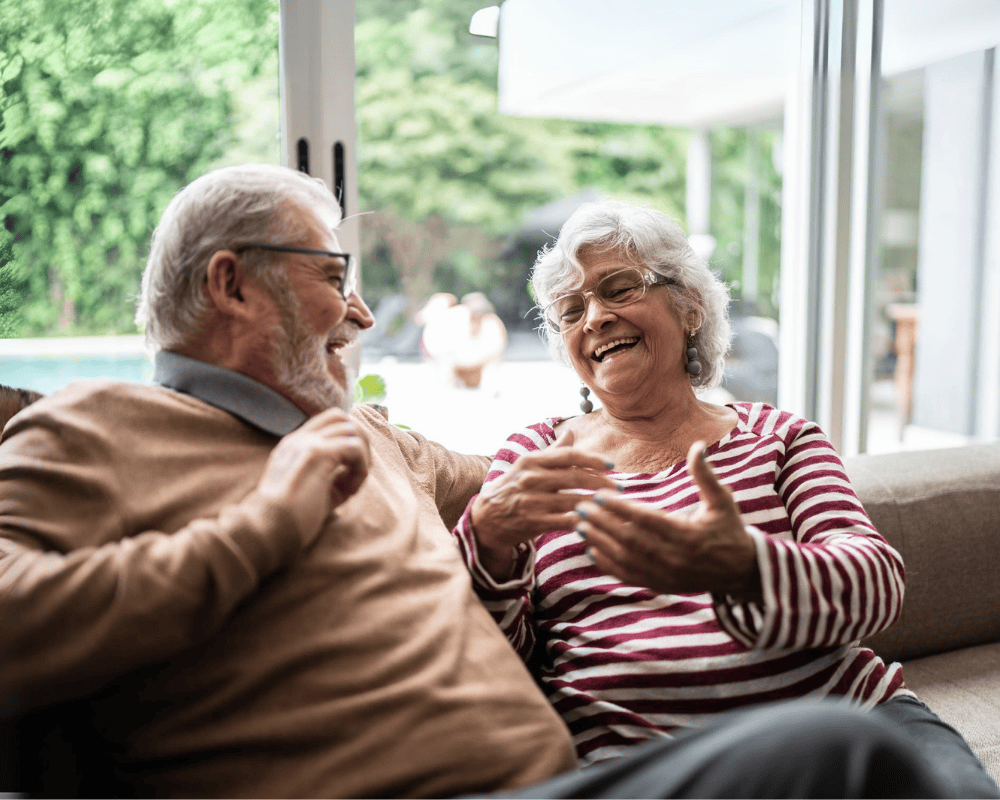 Retirees laughing while chatting