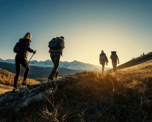 Hikers hiking towards sunset