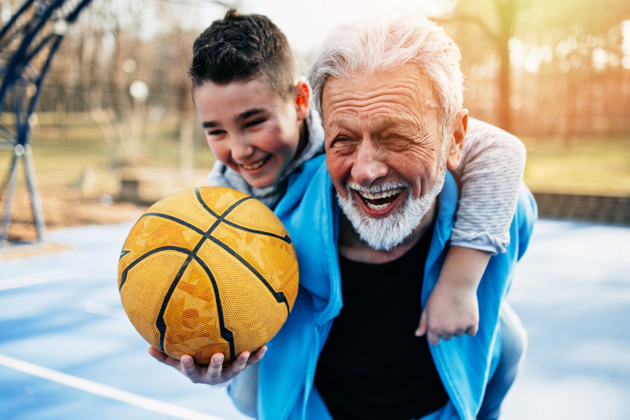 Grandfather playing basketball with his grandson