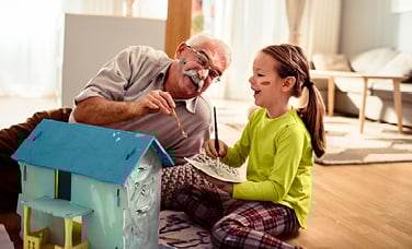 grandfather playing with his granddaughter