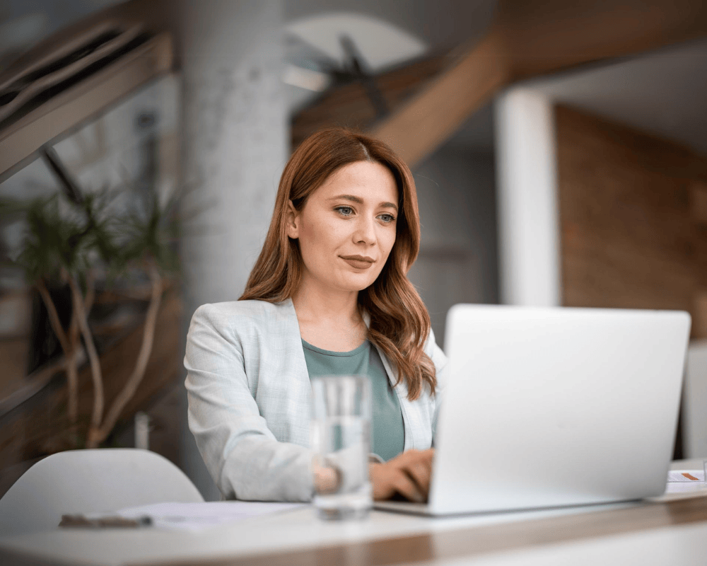 Successful businesswoman using laptop, working in office. Business technology corporate concept