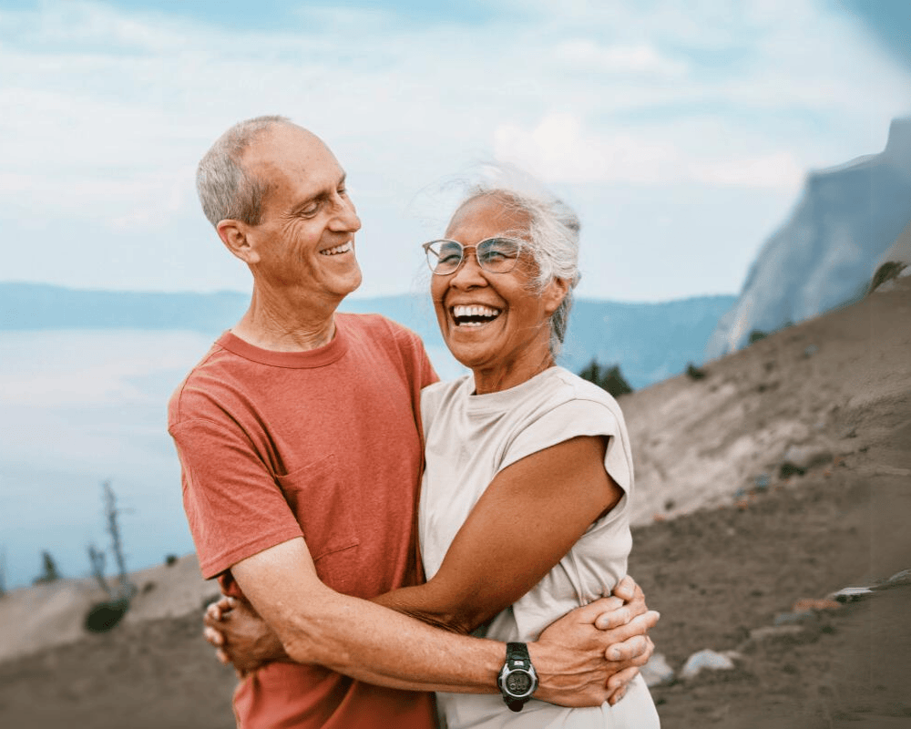 Retirees couple smiling on a hike