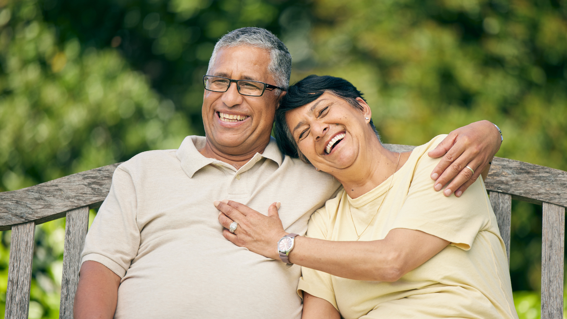 retired couple sitting on park bench