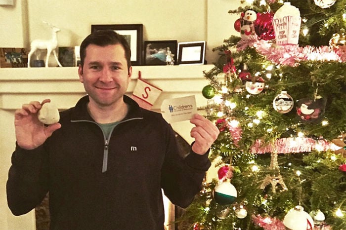 Man Standing in Front of Christmas Tree
