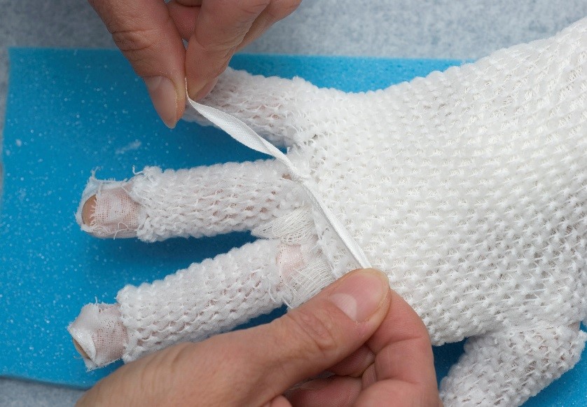Second layer of gauze on the hand