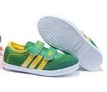 Pair of green shoes the sole of one is visible