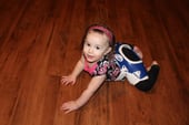 girl crawling with hip abduction brace on