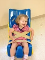 child in tumble seat