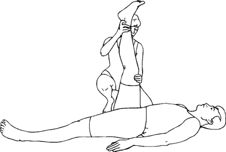 woman stretching man's leg