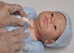 cpr being done on doll with trach
