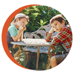 Photo of two children at a table not talking