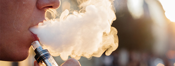 Photo of male exhaling vape cloud
