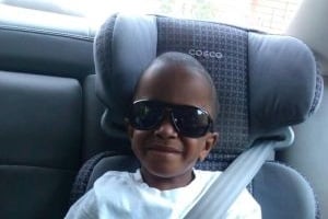 Messiah in a carseat with sunglasses on