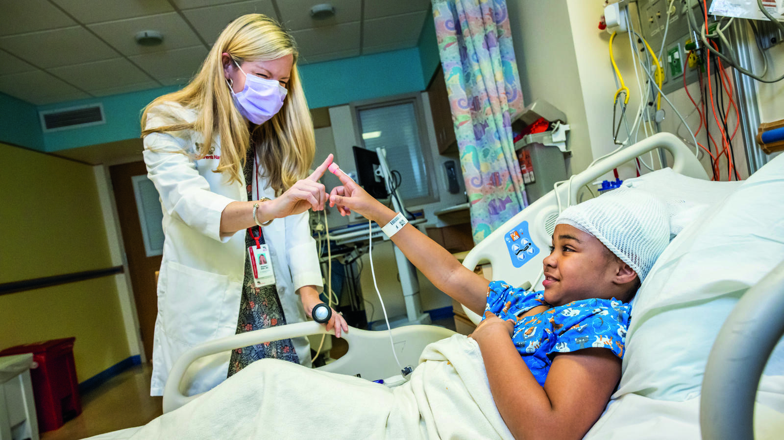 A neurologist performing an exam on a patient in hospital bed