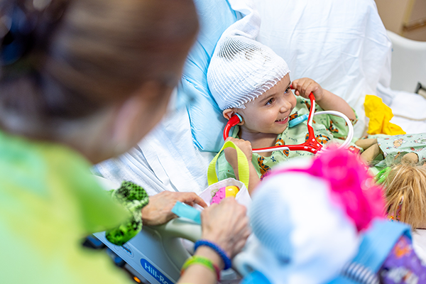 Happy child playing with toy stethoscope