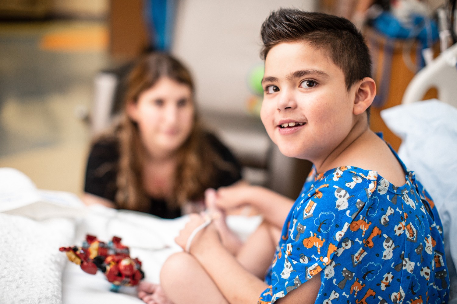 Patient in hospital bed with nurse