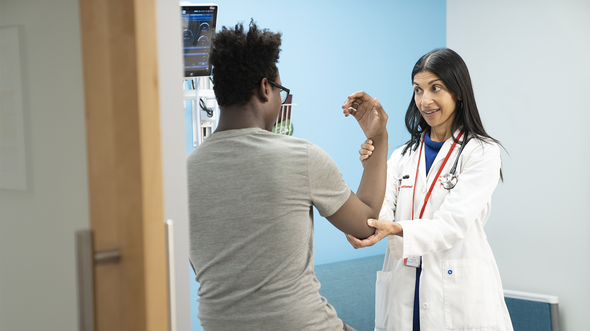 Provider checking a patients arm injury