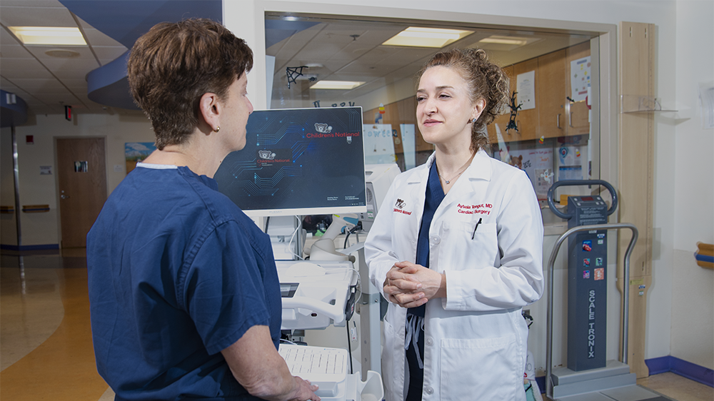 Two provider standing in the hallway talking