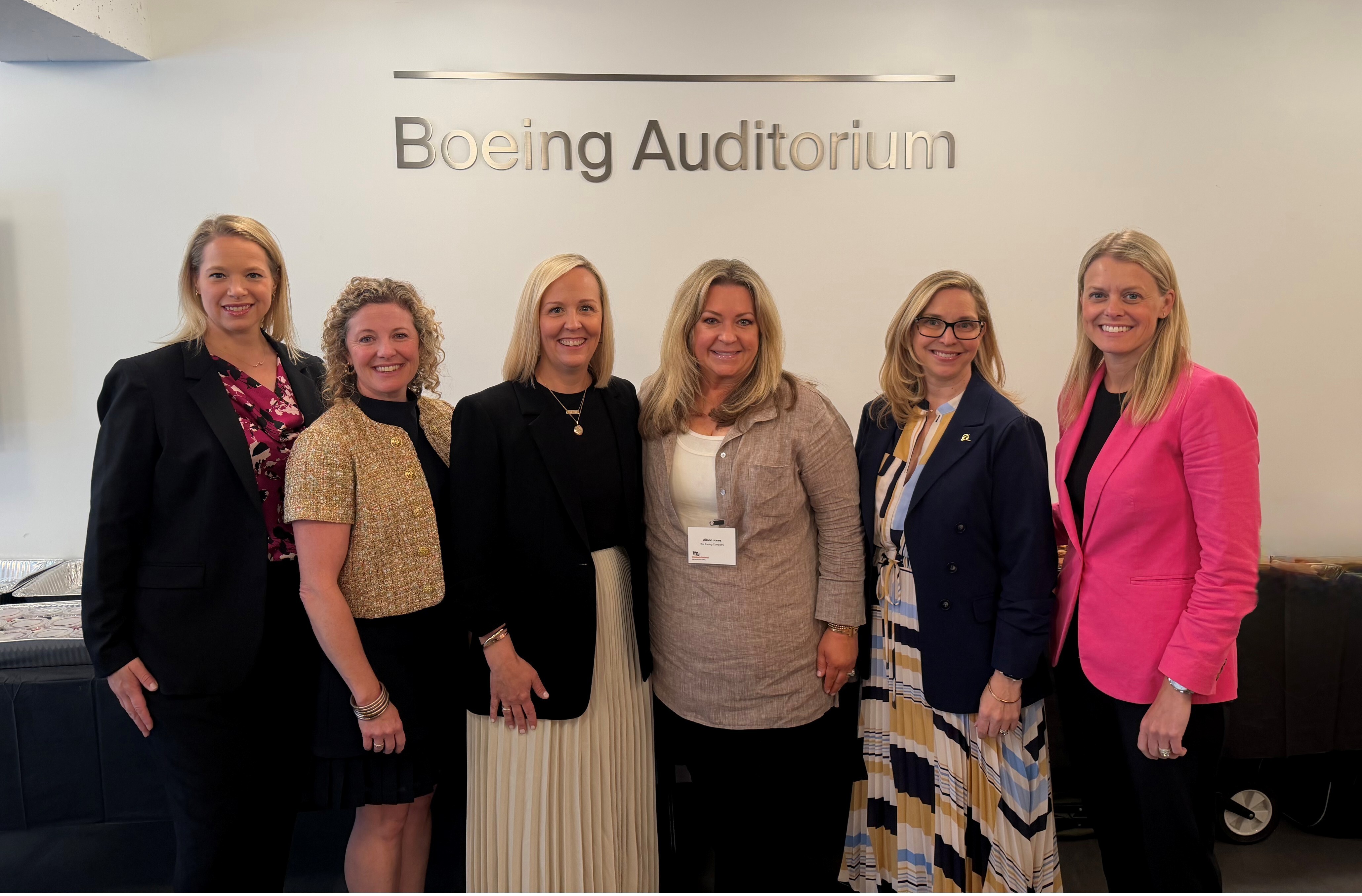 Group photo in front of the Boeing Auditorium sign