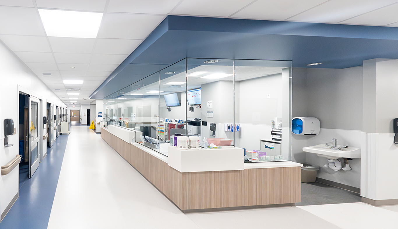 Emergency department hallway leading to patient rooms and the nurses station.