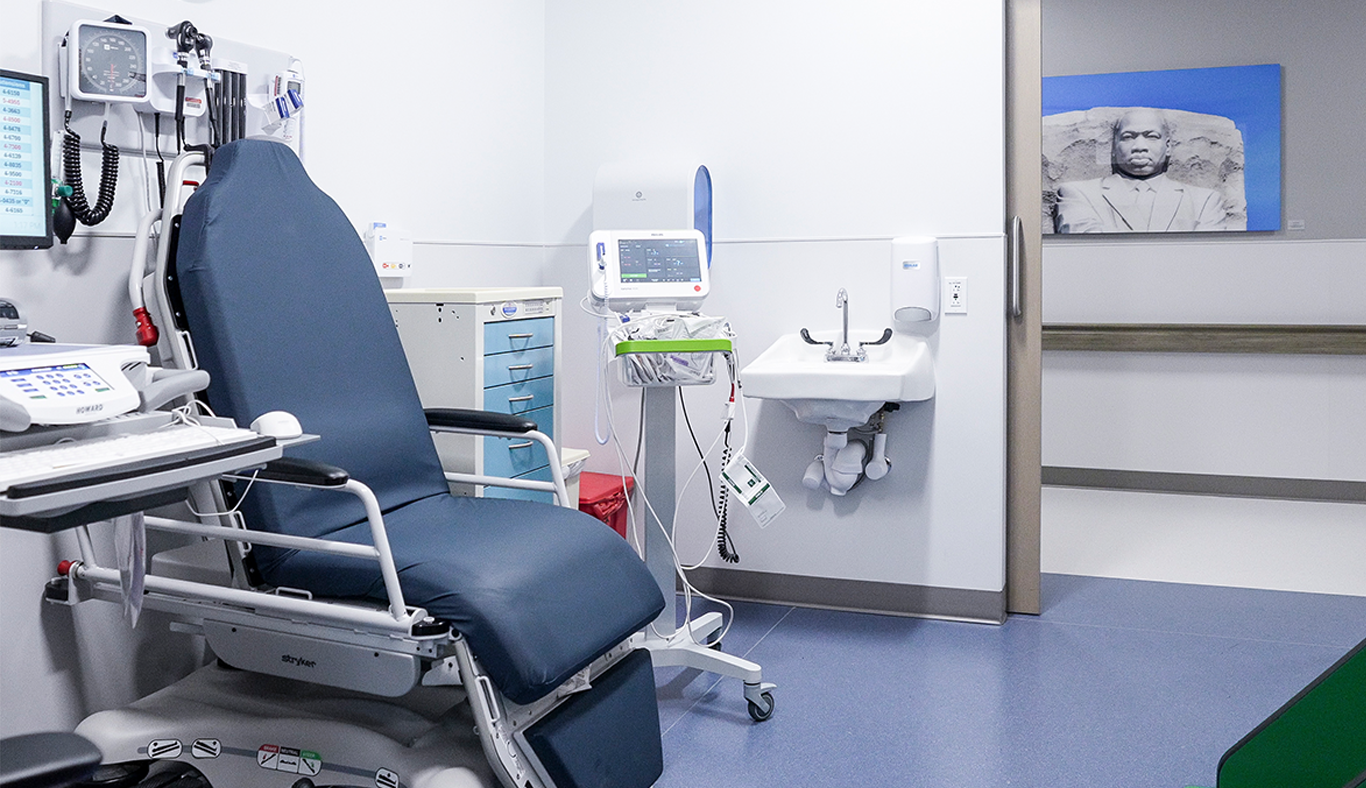 Exam room with specialized chair and equipment for patients.