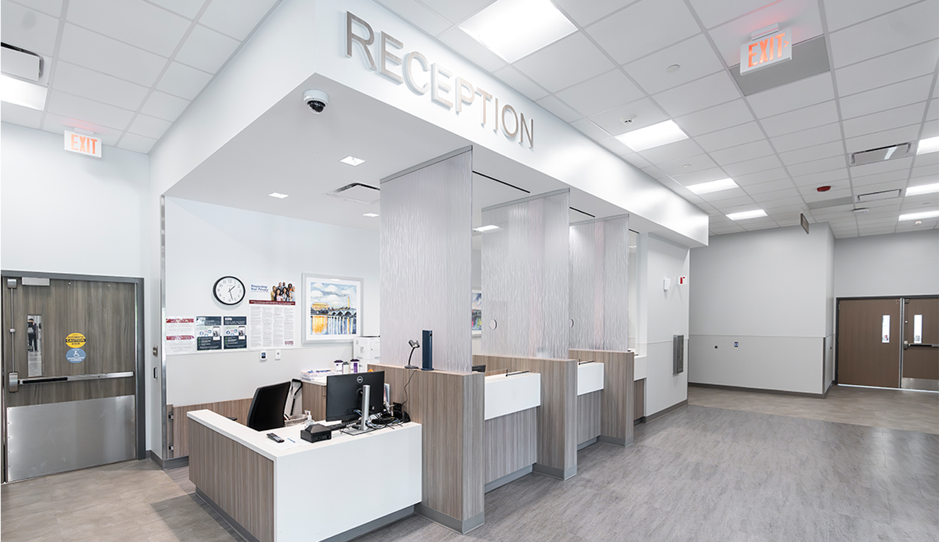 Front desk with a sign over top that says reception