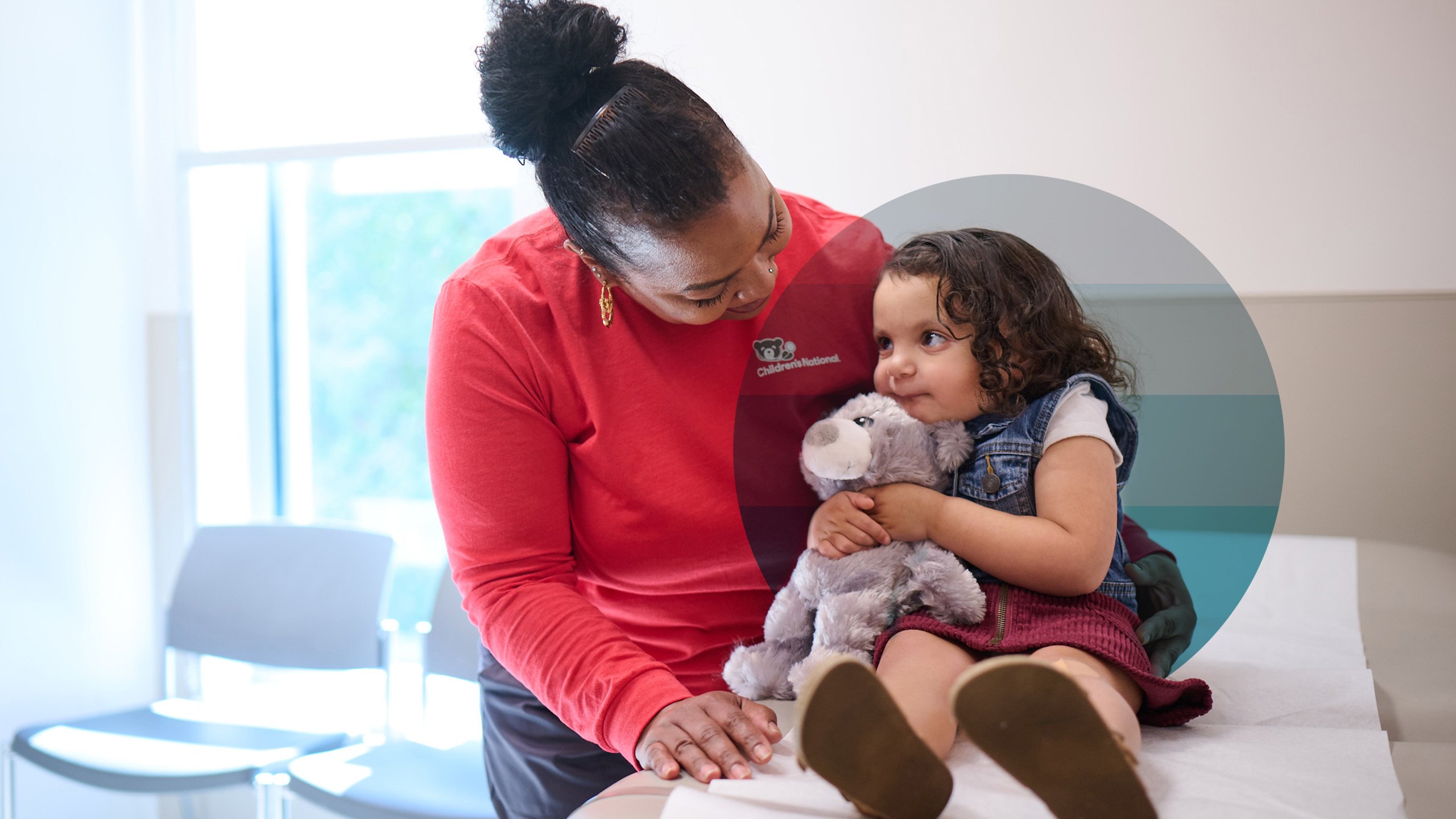 healthcare provider comforts child with stuffed animal