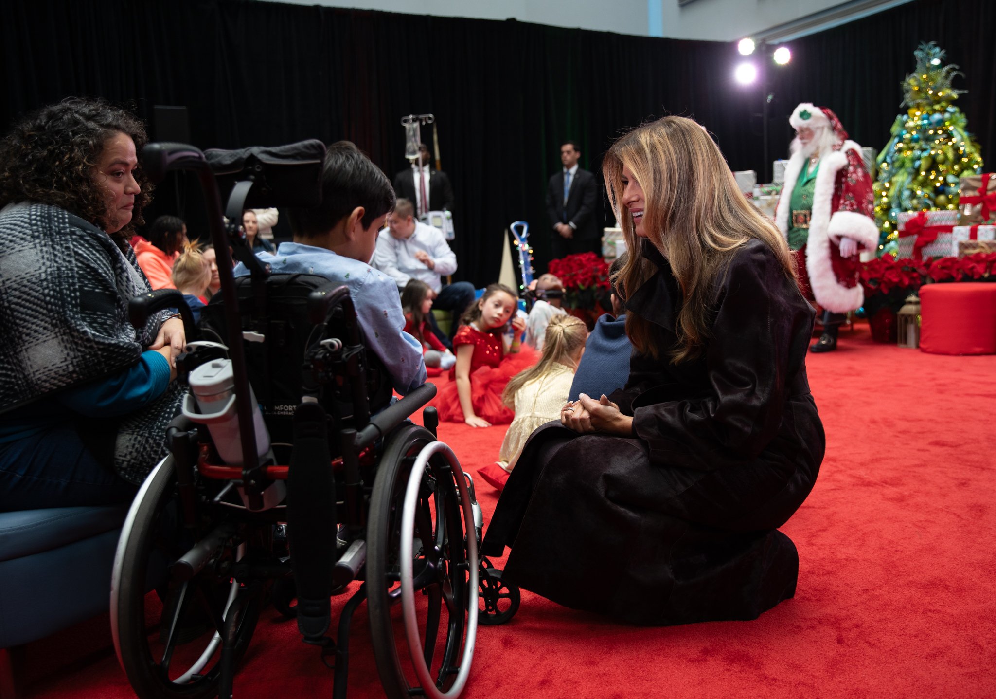 The First Lady talking to a child in a wheelchair