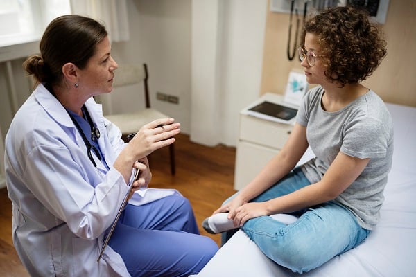 Doctor with teen girl