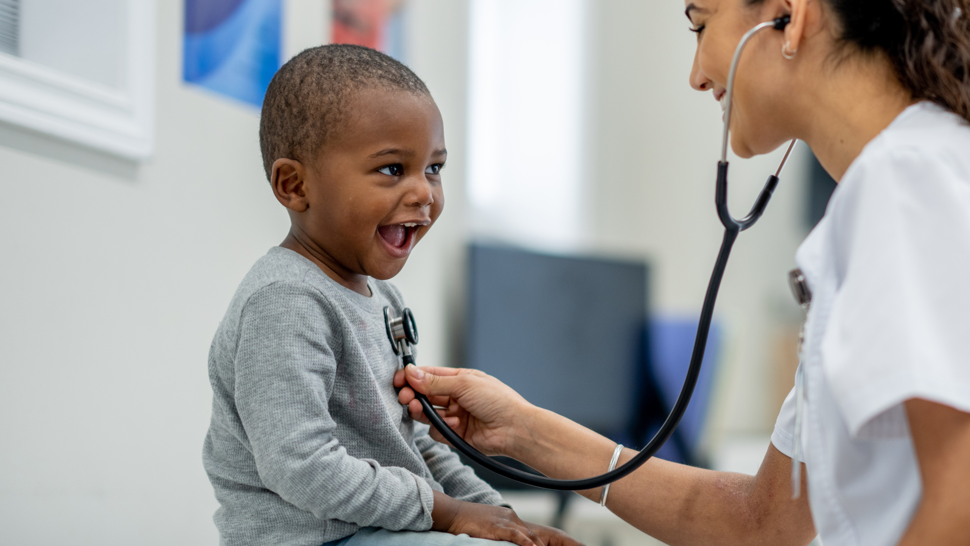 doctor with stethoscope examines young boy