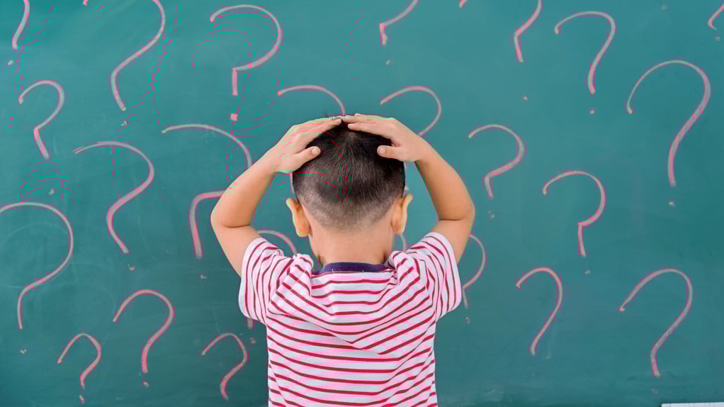 boy with hands on his head