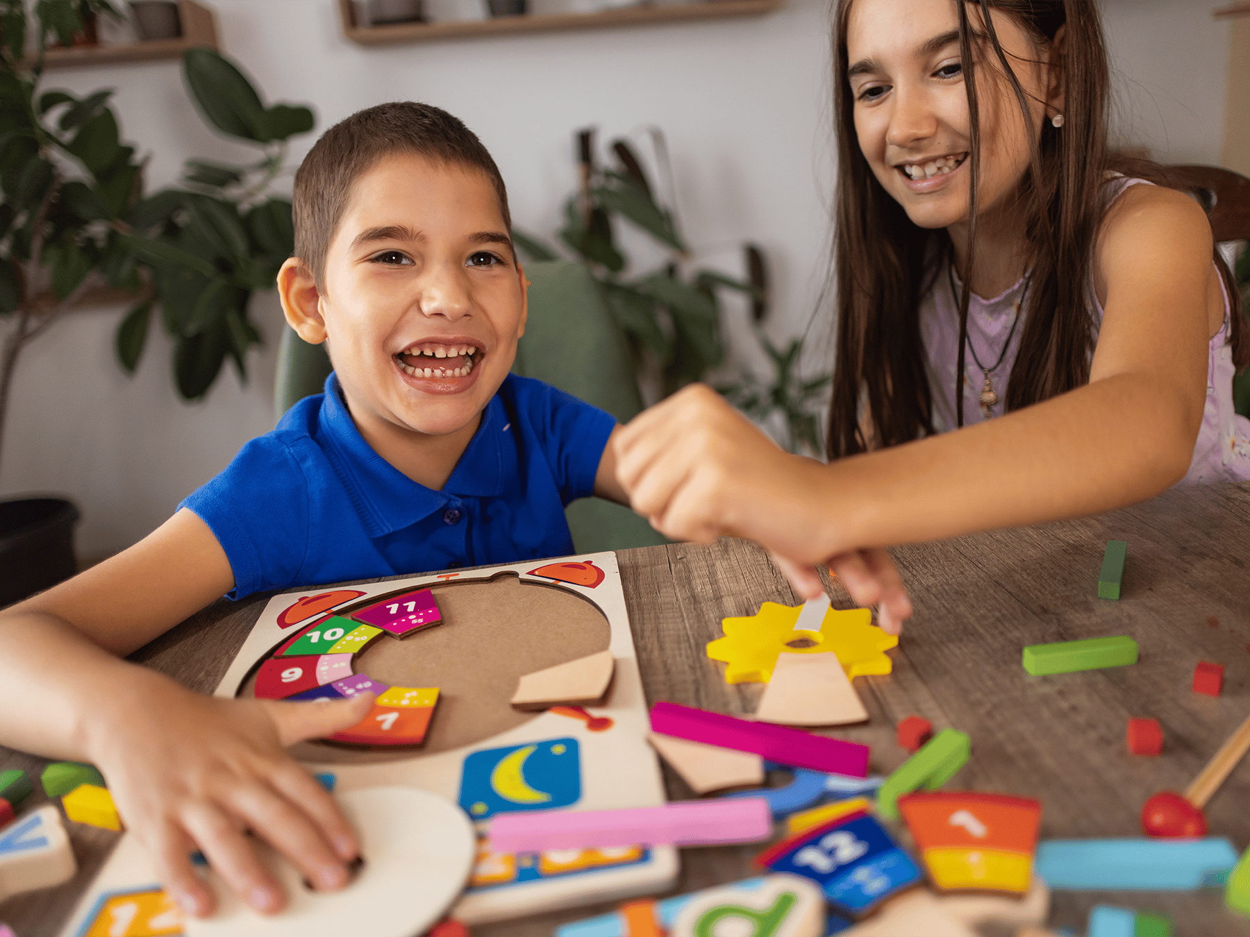 boy and girl smiling doing puzzles together