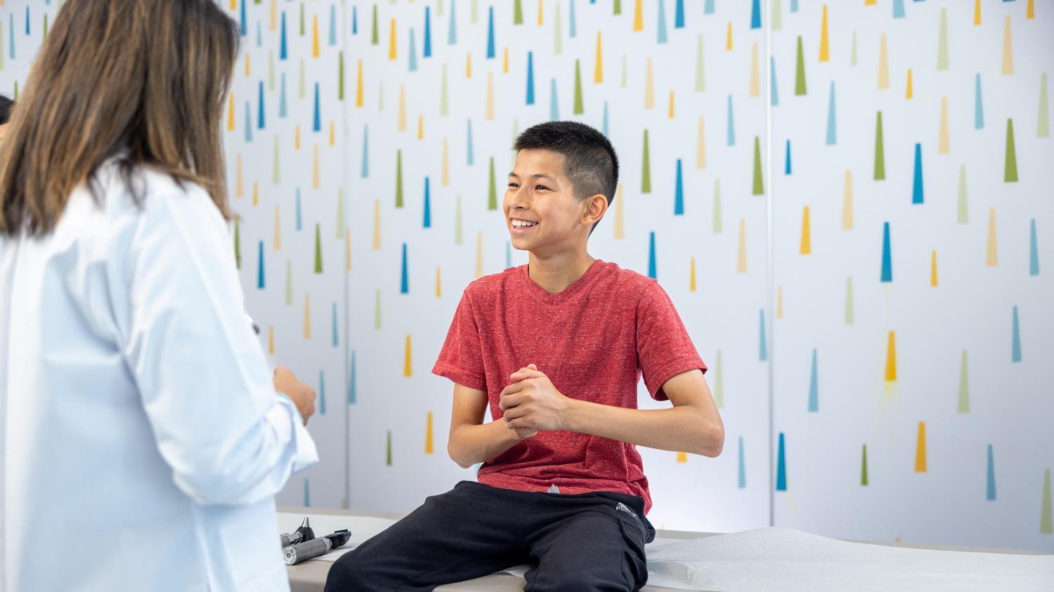 teen boy speaking with a doctor