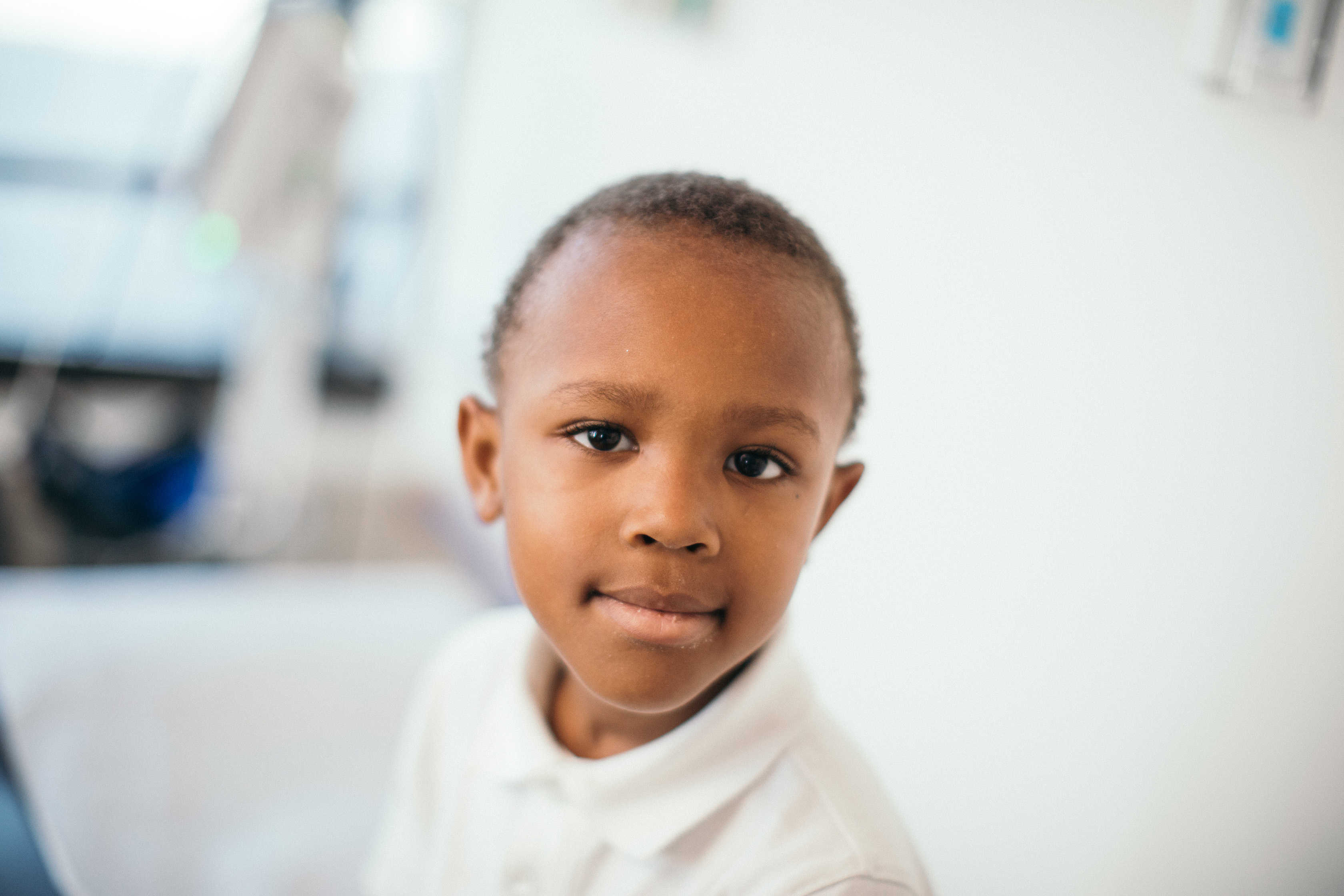 A Little Boy In White Shirt in Exam Room.