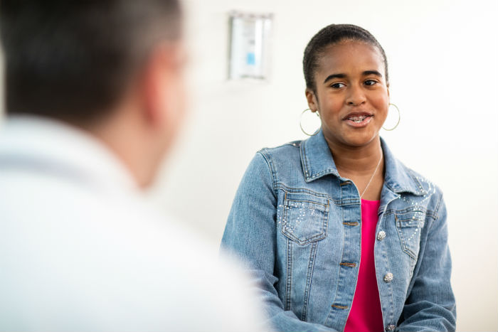 Cardiologist and a Teenage Patient talking.