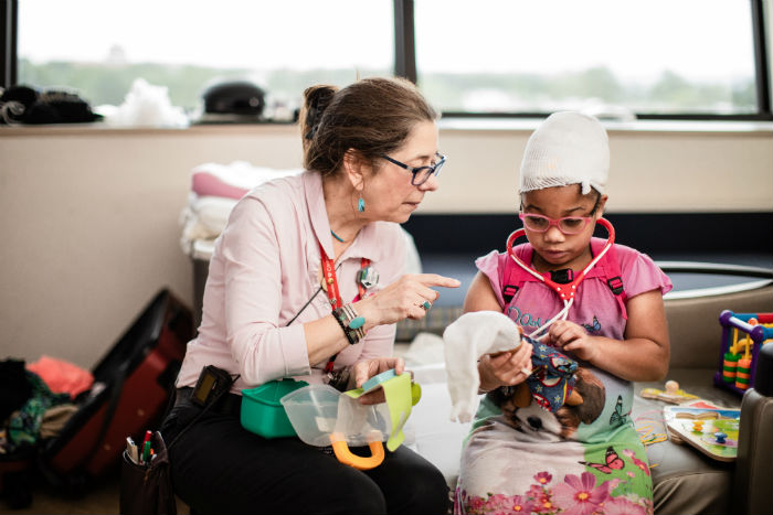 Female Patient with Stethoscope, Accompanied by a Female Adult.