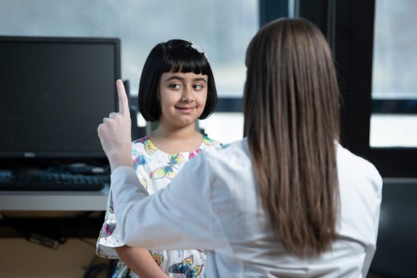 Female provider conducting a follow my finger with your eyes on a little girl