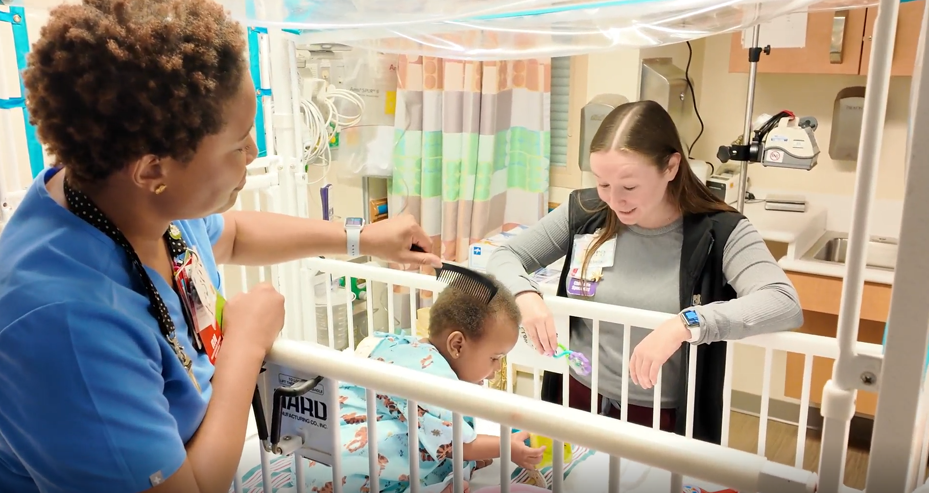 Nurse combing baby's hair